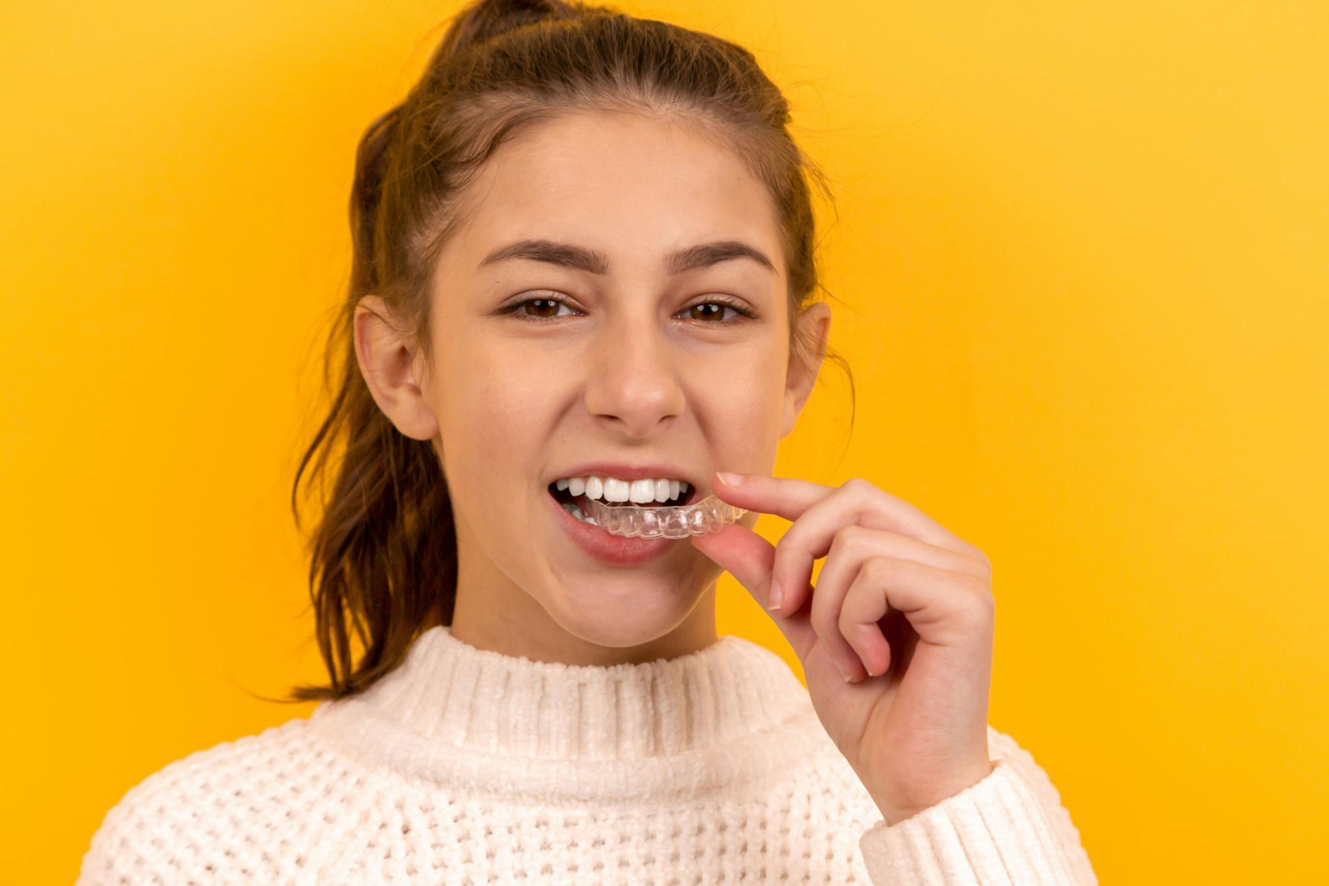 Side-by-side comparison of Invisalign clear aligners and traditional braces for patients in McKinney, TX